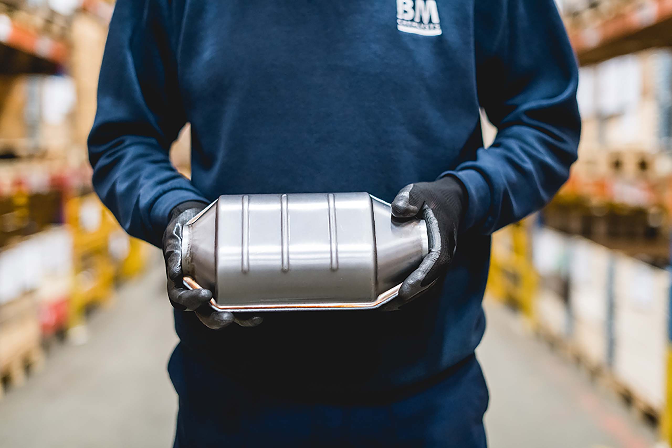 A BM Catalyst worker is holding a DPF